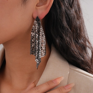 Minimalist gunmetal mesh tassel earrings with triangle studs shown on fashion model