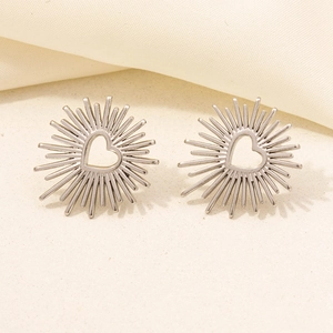 Detailed macro view of 304 stainless steel heart-shaped stud earrings with sunburst pattern