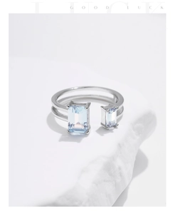 Detail of s925 silver double-row open ring with rectangular light blue stones