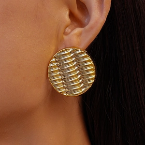 Golden acrylic wavy geometric round stud earring with textured finish on model