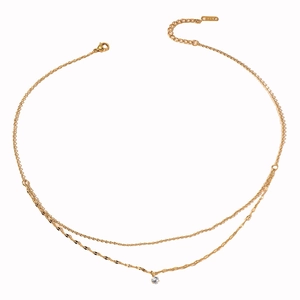 Elegant double-layered gold stainless steel necklace with a zircon pendant on a white background