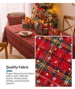 Detail of red plaid Christmas tablecloth featuring snowflake patterns and jacquard texture