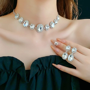 Detailed close-up of a French style silver oval rhinestone necklace and earring set