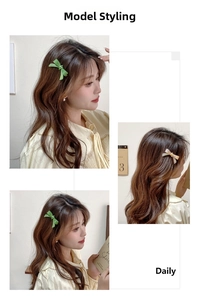 Detail view of acetate bow hair clips in green and cream worn on a model's hair side