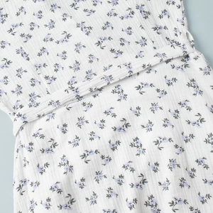 Detail of the soft cotton floral fabric with drawstring waist and natural texture