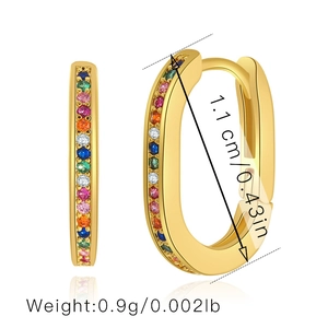 Detail view of gold hoop earrings with multi-colored zircons showing size and weight