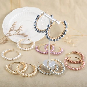Detailed view of handmade beaded hoop earrings featuring natural mother-of-pearl pearls