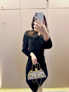 Detailed shot of an elegant evening bag with pearls and rhinestones on a gold frame