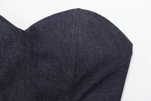 Macro shot of dark indigo denim bustier featuring a heart neckline and contrast stitching
