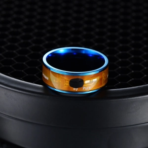 Smart NFC ring with blue metal outer band and gold-colored circuit board pattern interior