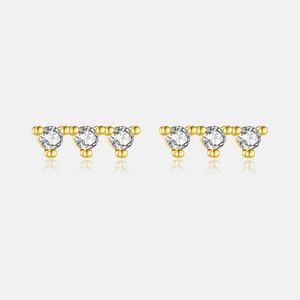 Detail view of gold S925 silver earrings featuring three aligned round cubic zirconia stones