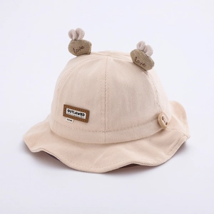 Detailed macro view of corduroy baby sun hat featuring cute ears and a leather patch