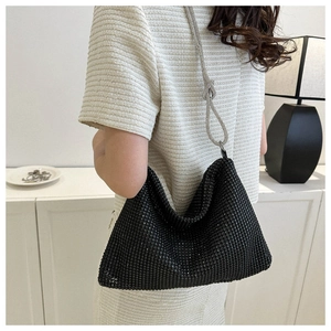 Detail of black rhinestone hobo bag with silver crystal chain and decorative knot