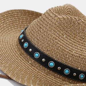 Detail of woven straw hat with sequins, turquoise beads and studded leather band