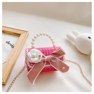 Pink tweed girls mini crossbody bag with bow, pearl handle and camellia detail