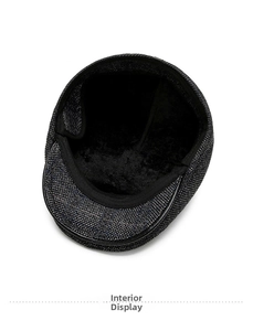 Detail of warm black faux fur lining inside a dark grey tweed newsboy cap for winter