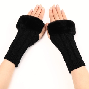 Detailed close-up of black knitted fingerless gloves with soft faux fur cuffs for winter