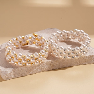 Multi-layer pearl bracelet with diamonds in gold and silver finish on stone base