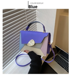 Detail of color-block geometric PU leather handbag with elegant gold metal rotary lock