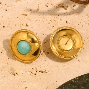Macro shot of gold-plated stainless steel stud earrings with round turquoise amazonite stones