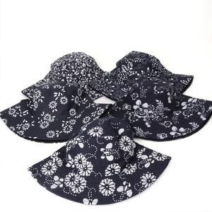 Reversible cotton floral bucket hats set in navy blue with daisy and flower prints