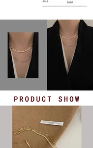 Detail view of double-layered 18k gold plated flat snake and paperclip chain necklace