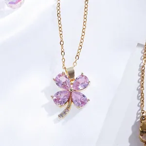 Close-up of a pink four-leaf clover pendant with 18K gold plated chain and crystal details