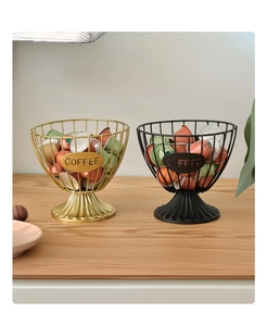 Close-up of gold and black wire coffee capsule storage baskets with COFFEE label