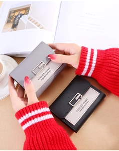 Close-up of litchi pattern PU leather wallets with elegant silver metal buckles