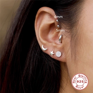 S925 sterling silver moon star and stud earrings set worn by a model on ear lobe
