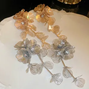 Long floral tassel earrings with sparkling zircons and resin petals in gold and silver