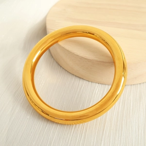 Classic minimalist 18K gold plated polished round bangle bracelet with a mirror finish