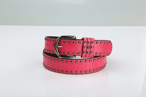 Detail of rose red leather belt with double row metal rivets and vintage prong buckle