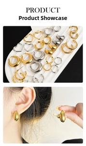 Close-up display of titanium steel hoop earrings in gold and silver heart and bamboo designs