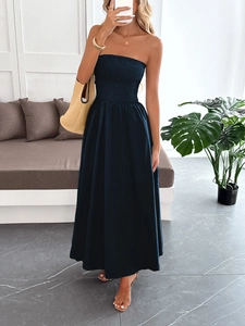 Elegant strapless deep blue smocked maxi dress with a flowing skirt for summer vacations