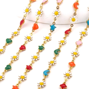 Macro view of colorful drip oil heart and flower charms on DIY stainless steel chains