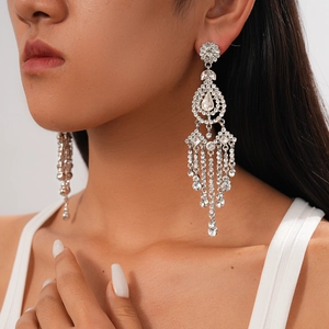 Exaggerated silver tassel earrings with rhinestones on model for realistic drape view