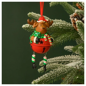 Close-up of reindeer Christmas bell ornament hanging on a snowy pine branch