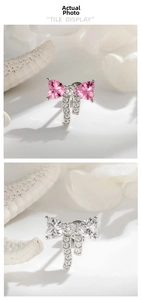 Macro detail of ribbon bow earrings with heart zircons and micro-pave crystals