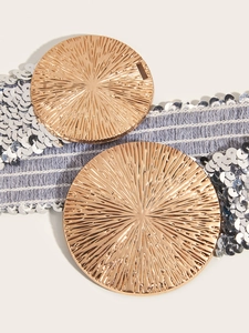 Detail of leopard print elastic waist belt with gold textured circular metal buckles