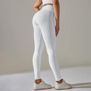 Macro shot of white high-waisted seamless yoga leggings with ribbed tummy control texture