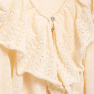 Elegant cream knit sweater with ruffle V-neck and delicate openwork floral pattern