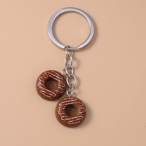 Close-up of realistic chocolate donuts with colorful sprinkles on a metal keychain