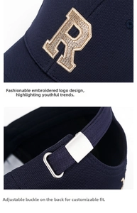 Detail of navy blue baseball cap with gold R embroidery and silver metal buckle closure