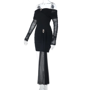 Detail of off-shoulder mesh long sleeves and metallic hardware on black bodycon dress