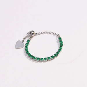 Close-up of adjustable silver bracelet with green zircon stones and heart charm
