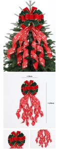 Detail of a large red and green Christmas tree topper bow with festive holiday prints