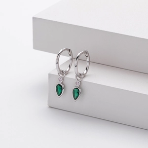 Elegant s925 sterling silver drop earrings with pear-shaped green zircon on white pedestal