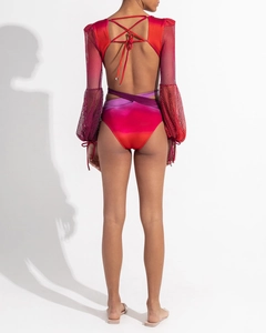 Detailed back view of gradient long sleeve swimsuit with crisscross straps and red mesh