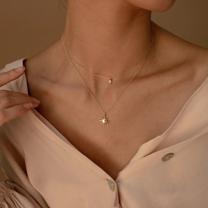 Layered 18K gold-plated titanium steel necklace with star pendant and zircon on a model